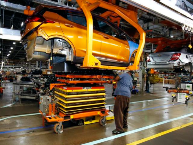 A battery is lifted into place for installation in the Chevrolet Bolt EV at the General Motors Orion Assembly plant Friday, Nov. 4, 2016, in Orion Township, Mich. The Chevrolet Bolt can go more than 200 miles on battery power and will cost less than the average new vehicle in …