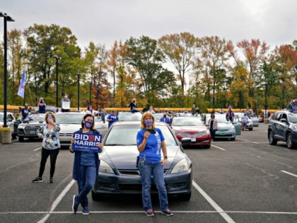 BRISTOL, PA - OCTOBER 24: Standing near their cars, supporters listen as Democratic presid