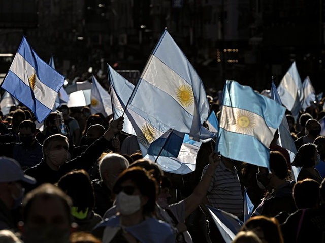People take part in a protest against the government of Argentina's President Alberto Fernandez with Argentinian flags at Plaza de la Republica square in Buenos Aires on October 12, 2020, amid a lockdown against the spread of the COVID-19 coronavirus. - Thousands demonstrated again Monday in several cities of Argentina …