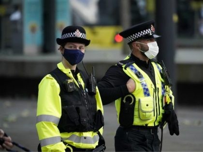 MANCHESTER, UNITED KINGDOM – OCTOBER 20: Police officers wear face masks as they patrol