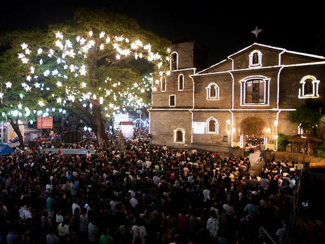 People attend the first of nine dawn masses signalling the official start of Christmas at