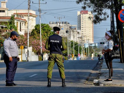 Police officers strengthen security in El Carmelo neighbourhood in Havana on April 4, 2020