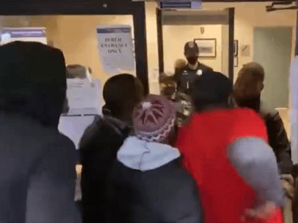 Protesters try to push their way into a Washington, D.C. police headquarters building. (Tw