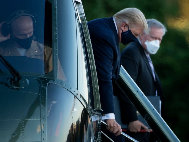White House Chief of Staff Mark Meadows (R) watches as US President Donald Trump walks off Marine One while arriving at Walter Reed Medical Center in Bethesda, Maryland on October 2, 2020. - President Donald Trump will spend the coming days in a military hospital just outside Washington to undergo treatment for the coronavirus, but will continue to work, the White House said Friday (Photo by Brendan Smialowski / AFP) (Photo by BRENDAN SMIALOWSKI/AFP via Getty Images)