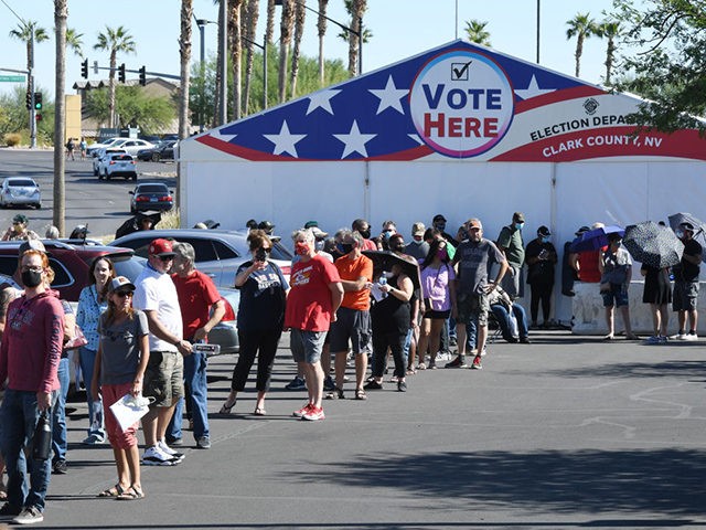 LAS VEGAS, NEVADA - OCTOBER 17: People line up to vote at a shopping center on the first day of in-person early voting on October 17, 2020 in Las Vegas, Nevada. Early voting for the general election in the battleground state continues through October 30. (Photo by Ethan Miller/Getty Images)