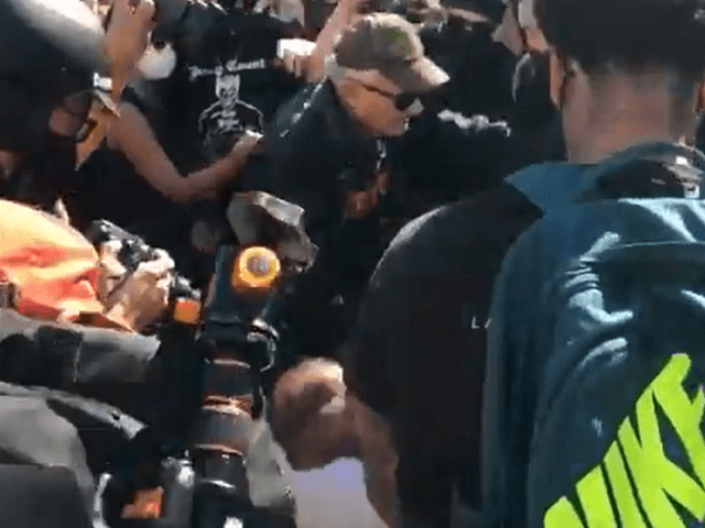 Antifa activists push elderly man to ground at San Francisco Free Speech Rally. (Mallory Moench)
