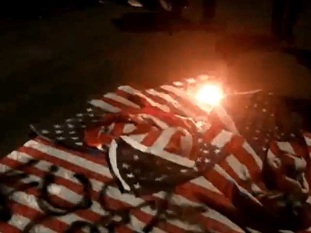 Flags stolen by protesters burned in New York streets during anti-police union march. (Twitter Video Screenshot/Dean Moss)