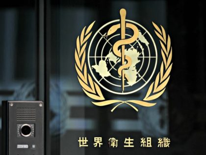 A photo taken in the late hours of August 17, 2020 shows a sign of the World Health Organization (WHO) written in Chinese at the entrance of their headquarters in Geneva amid the COVID-19 outbreak, caused by the novel coronavirus. (Photo by Fabrice COFFRINI / AFP) (Photo by FABRICE COFFRINI/AFP …