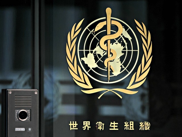A photo taken in the late hours of August 17, 2020 shows a sign of the World Health Organization (WHO) written in Chinese at the entrance of their headquarters in Geneva amid the COVID-19 outbreak, caused by the novel coronavirus. (Photo by Fabrice COFFRINI / AFP) (Photo by FABRICE COFFRINI/AFP via Getty Images)