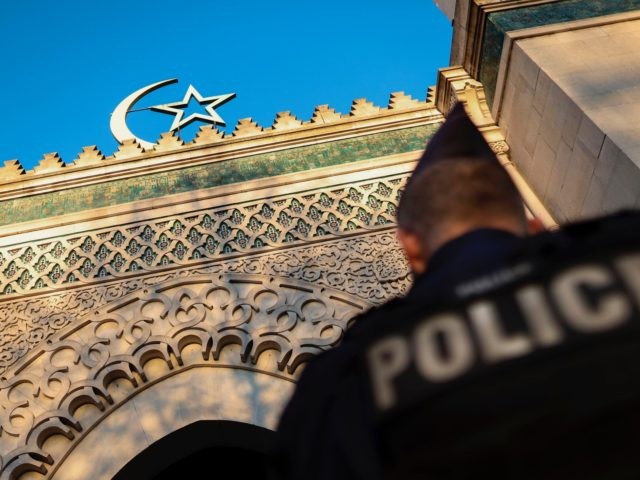 A French police officer stands guard in front of the entrance of the Grande Mosquee de Par