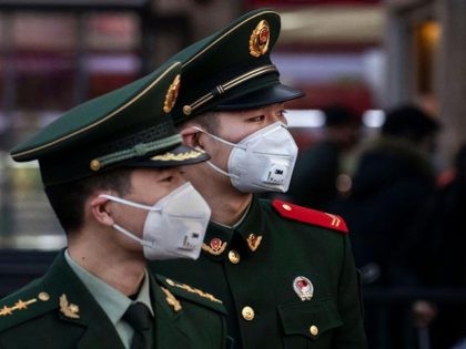BEIJING, CHINA - JANUARY 22: Chinese police officers wear protective masks at Beijing Stat