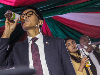 Madagascar's President Andry Rajoelina drinks a sample of the "Covid Organics" or CVO reme