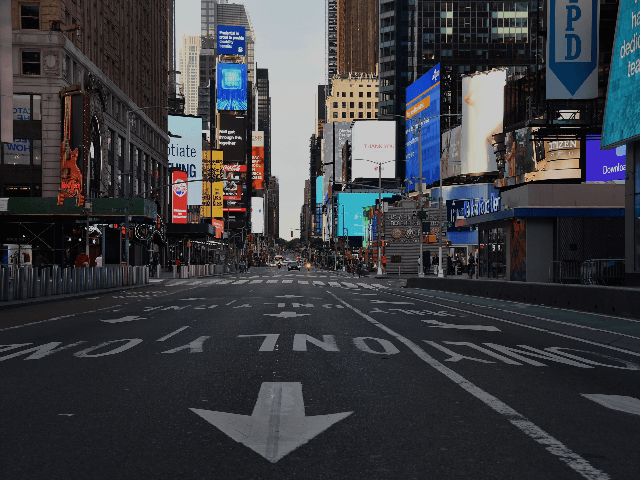 A car approaches on a nearly empty street near Times Square on May 27, 2020 in New York City. (Photo by Angela Weiss / AFP) (Photo by ANGELA WEISS/AFP via Getty Images)