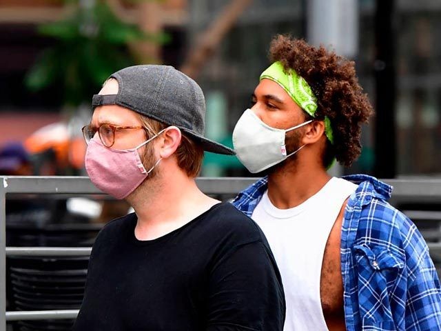 Young men wearing facemasks due to the coronavirus pandemic are seen in Los Angeles on June 29, 2020 where the largest single-day number of new COVID-19 cases in the county since the pandemic began was confirmed, with a spike among the younger population. - The coronavirus pandemic is "not even …