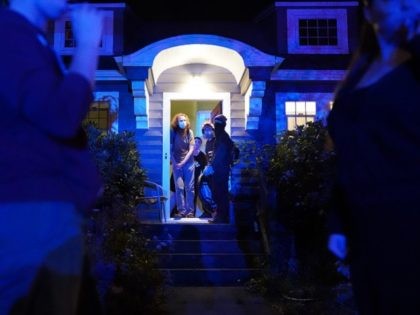 PORTLAND, OR - AUGUST 10: Protesters take shelter in the front door of a house near the Portland Police Bureau North Precinct as the homeowners tell passing crowds to take shelter inside during a crowd dispersal on August 10, 2020 in Portland, Oregon. Neighborhood residents regularly aid protesters as police …