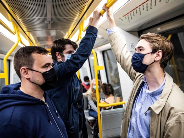 People wear mask on a metro train in Copenhagen shortly after midnight, on August 22, 2020