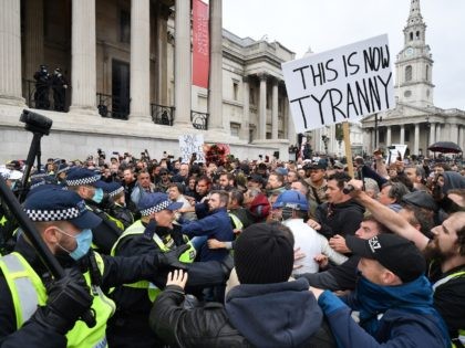 TOPSHOT - Police move in to disperse protesters in Trafalgar Square in London on September