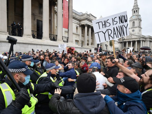 TOPSHOT - Police move in to disperse protesters in Trafalgar Square in London on September