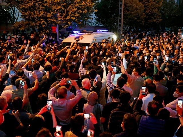 Fans of Iranian singer, instrumentalist and composer Mohammad-Reza Shajarian gather outside the Jam hospital in Tehran where he has died on October 8, 2020. - Singer, instrumentalist and composer Mohammad-Reza Shajarian, who died today aged 80, embodied traditional and classical Iranian music for more than half a century both at …