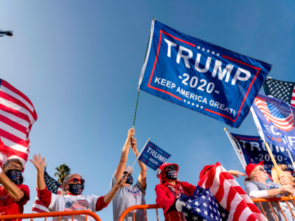 Supporters of US President Donald Trump hold signs and wave US national flags during a rally in Beverly Hills, California, October 10, 2020. (Photo by Kyle Grillot / AFP) (Photo by KYLE GRILLOT/AFP via Getty Images)