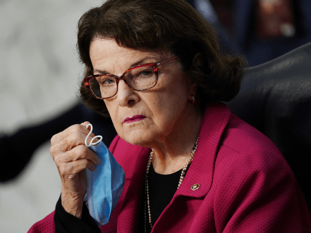 Ranking member Sen. Dianne Feinstein (D-CA) holds her facemask during the second day of th