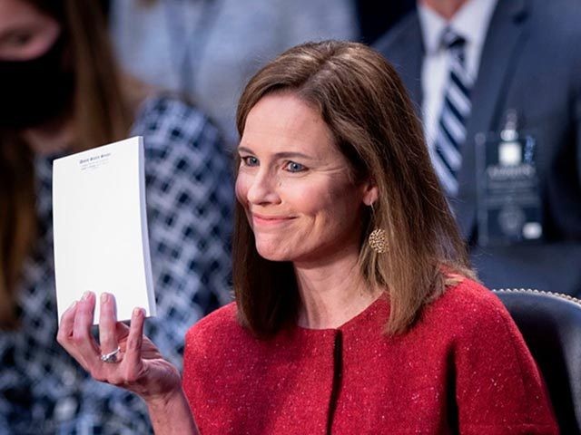 Judge Amy Coney Barrett, holds up a blank notepad after Senator John Cornyn asked her what documents she had on her desk during the second day of her Senate confirmation hearing to the Supreme Court on Capitol Hill in Washington, DC on October 13, 2020. - President Donald Trump's US …