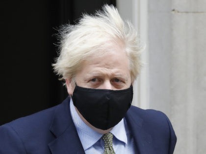 Britain's Prime Minister Boris Johnson, wearing a face mask or covering due to the COVID-19 pandemic, leaves number 10 Downing Street in central London on October 14, 2020, to take part in the Prime Minister Question (PMQs) session in the House of Commons. (Photo by Tolga AKMEN / AFP) (Photo …