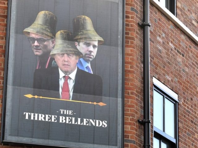 An image of Britain's Prime Minister Boris Johnson, Britain's Health Secretary Matt Hancock and Number 10 special advisor Dominic Cummings, is pictured on a sign outside the re-branded The James Atherton Pub in New Brighton, north west England, which has been renamed as 'The Three Bellends', in protest against the …