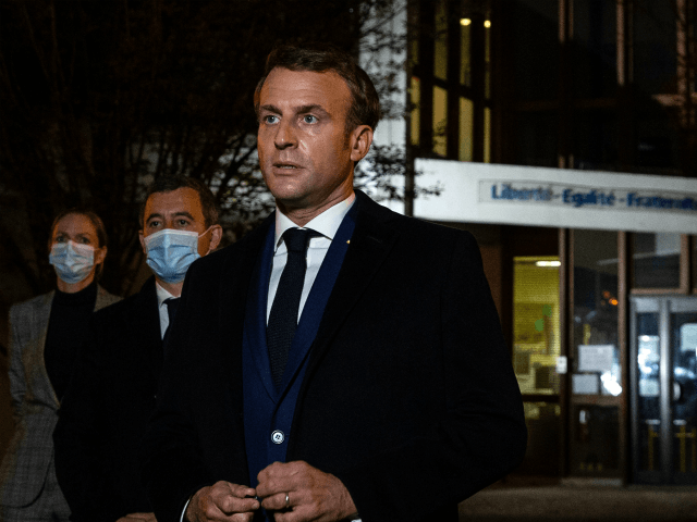 TOPSHOT - French President Emmanuel Macron (R), flanked by French Interior Minister Gerald Darmanin (2L), speaks to the press in front of a middle school in Conflans Saint-Honorine, 30kms northwest of Paris, on October 16, 2020, after a teacher was decapitated by an attacker who has been shot dead by …