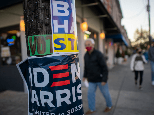 PHILADELPHIA, PA - OCTOBER 17: A man walks past a telephone pole affixed with several Bide