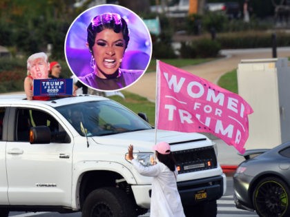 (INSET: Cardi B) A woman wearing a Trump mask holds a sign from her car during a rally in support of US President Donald Trump in Beverly Hills, California, October 17, 2020. (Photo by Chris DELMAS / AFP) (Photo by CHRIS DELMAS/AFP via Getty Images)