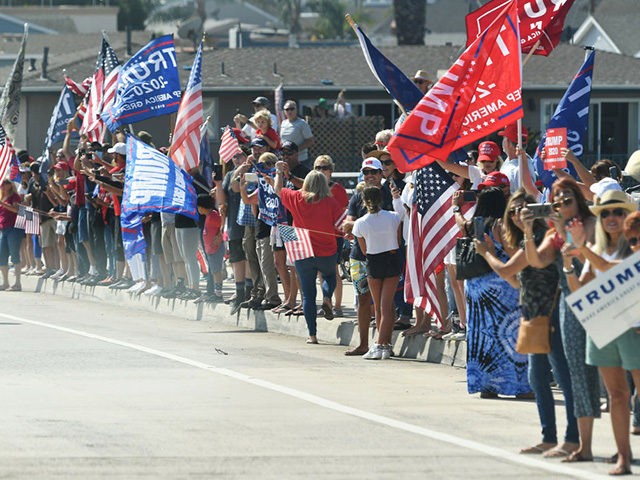 Supporters cheer as the motorcade of US President Donald Trump passes by near John Wayne Airport in Santa Ana, California on October 18, 2020. - Trump is heading to Newport Beach, California a fundraiser. (Photo by MANDEL NGAN / AFP) (Photo by MANDEL NGAN/AFP via Getty Images)