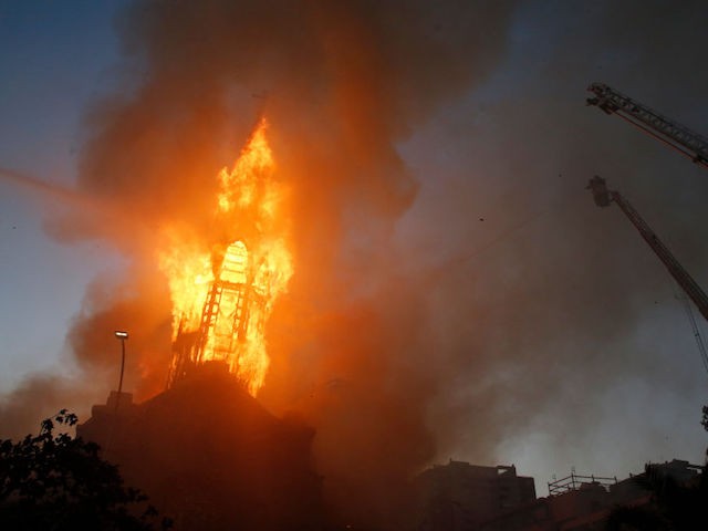 SANTIAGO, CHILE - OCTOBER 18: La Asuncion church burns during a protest on October 18, 2020 in Santiago, Chile. A series of protests and social unrest arose after a subway fare increase. It developed in a movement demanding improvements in basic services, fair prices and benefits including pensions, public health, and education. As a result, Chile will hold a referendum next Sunday to to decide whether or not to modify the Pinochet-era constituion. (Photo by Marcelo Hernandez/Getty Images)