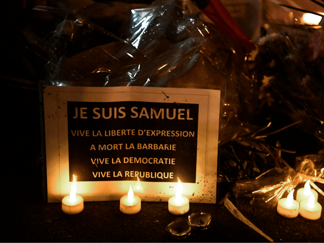 TOPSHOT - This picture taken on October 20, 2020, during the 'Marche Blanche' in Conflans-Sainte-Honorine, northwest of Paris, shows a sign reading 'I am Samuel. Long live freedom of expression' in solidarity after a teacher was beheaded for showing pupils cartoons of the Prophet Mohammed. His murder in a Paris …