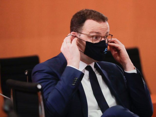 German Health Minister Jens Spahn adjusts his face mask as he attends the weekly cabinet m
