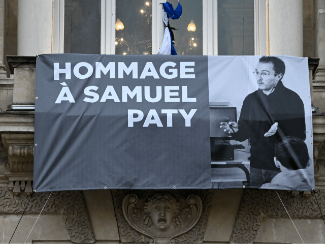TOPSHOT - A portrait of French teacher Samuel Paty is displayed on the facade of the Opera Comedie in Montpellier on October 21, 2020, during a national homage to the teacher who was beheaded for showing cartoons of the Prophet Mohamed in his civics class. - France pays tribute on …