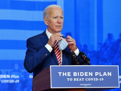 Democratic presidential nominee and former Vice President Joe Biden removes his mask as he