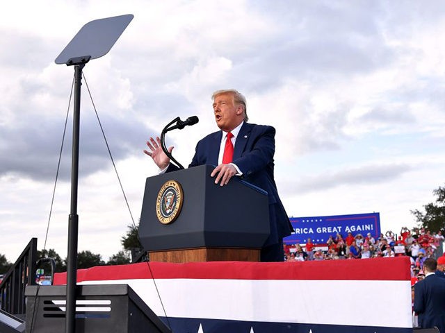 US President Donald Trump gestures as he speaks during a campaign rally at The Villages Po