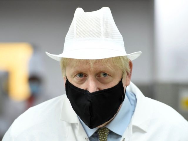 Britain's Prime Minister Boris Johnson, wearing a face mask or covering due to the COVID-19 pandemic, reacts during his visit to Royal Berkshire NHS Hospital in Reading, west of London on October 26, 2020, to mark the publication of a new review into hospital food. (Photo by Jeremy Selwyn / …