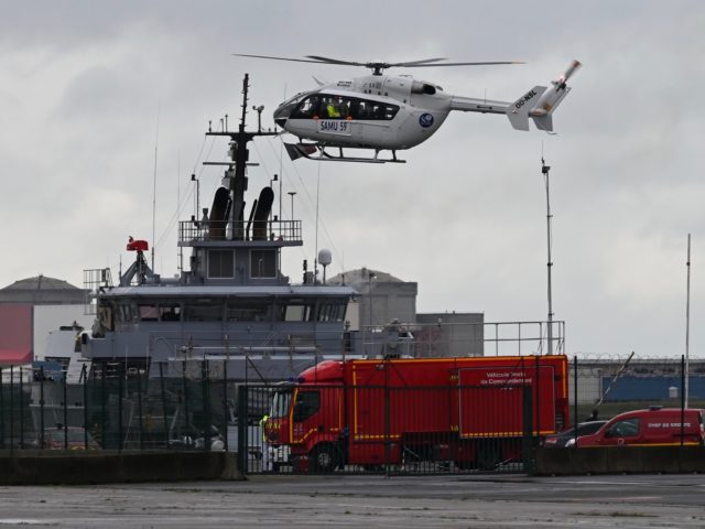 This photograph taken on October 27, 2020 shows a SAMU (French Urgent Medical Aid Service) helicopter landing at Dunkirk port, northern France after a small boat carrying migrants sank and a man was found dead. - The French authorities announced that at least one man drowned on October 27, 2020 …
