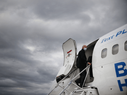 Wearing a mask to reduce the risk posed by the coronavirus, Democratic presidential nominee Joe Biden boards his plane at Gerald Ford Airport after campaigning October 02, 2020 in Grand Rapids, Michigan. Biden said he tested negative twice Friday for the coronavirus after it was reported that U.S. President Donald …