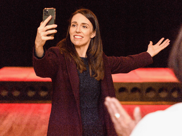New Zealand Prime Minister Jacinda Ardern takes a video as she meets members of the public