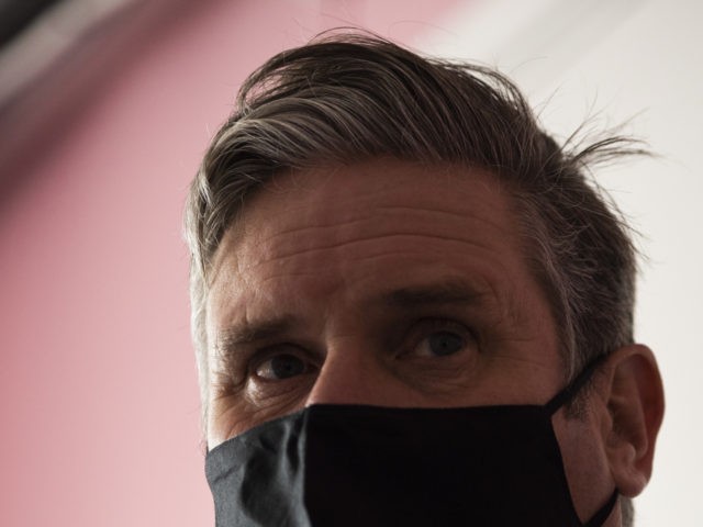 LONDON, ENGLAND - OCTOBER 06: Labour leader Keir Starmer wears a face mask while speaking to staff during a visit to 'The Project Surgery' on October 06, 2020 in London, England. Mr Starmer visited 'The Project Surgery' in Newham to speak to staff about their experiences during the Covid-19 pandemic. …