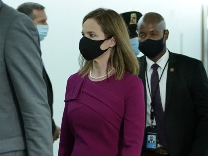 WASHINGTON, DC - OCTOBER 12: Supreme Court nominee Judge Amy Coney Barrett walks to her Senate Judiciary Committee confirmation hearing on Capitol Hill on October 12, 2020 in Washington, DC. Barrett was nominated by President Donald Trump to fill the vacancy left by Justice Ruth Bader Ginsburg who passed away …