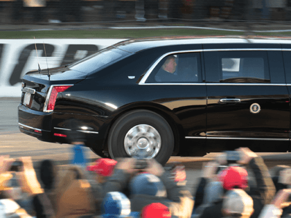 President Donald Trump circles the racetrack as he arrives for a campaign rally at the LaC