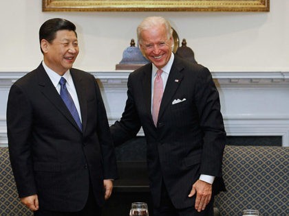 WASHINGTON, DC - FEBRUARY 14: (AFP OUT) U.S. Vice President Joe Biden (R) and Chinese Vice President Xi Jinping laugh during an expanded bilateral meeting with other U.S. and Chinese officials in the Roosevelt Room at the White House February 14, 2012 in Washington, DC. While in Washington, Vice President …