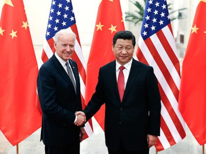Chinese President Xi Jinping (R) shakes hands with US Vice President Joe Biden (L) inside the Great Hall of the People in Beijing on December 4, 2013. Biden arrived in Beijing to raise concerns over a Chinese air zone ramping up regional tensions, looking to bolster ties while also underscoring …