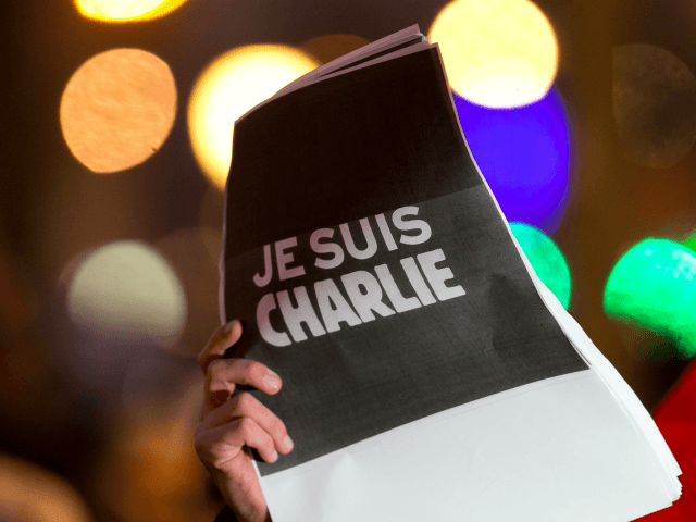 PARIS, FRANCE - JANUARY 07: Signs saying 'Je suis Charlie' are held up as crowds gather at 'Place de la Republique' for a vigil following the terrorist attack earlier today on January 7, 2015 in Paris, France. Twelve people were killed, including two police officers, as two gunmen opened fire …