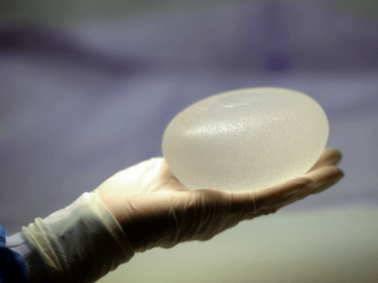 A picture taken on January 12, 2012 in Boissy-l'Aillerie, northern Paris, shows a technician presenting a silicone breast implant produced by French implant manufacturer, Sebbin laboratories. Around 300,000 women in 65 countries have received implants made by Poly Implant Prothese (PIP), a now-defunct manufacturer in southern France that is at …