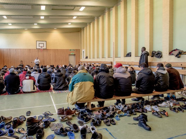 VANERSBORG, SWEDEN - FEBRUARY 12: Refugees pray in the gym of the Sweden's largest temporary camp for refugges at the former psychiatric hospital Restad Gard on February 12, 2016 in Vanersborg, Sweden. Last year Sweden received 162,877 asylum applications, more than any European country proportionate to its population. According to …